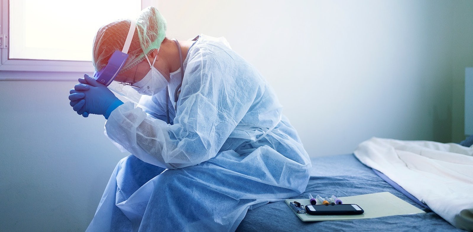 Stressed healthcare worker in PPE