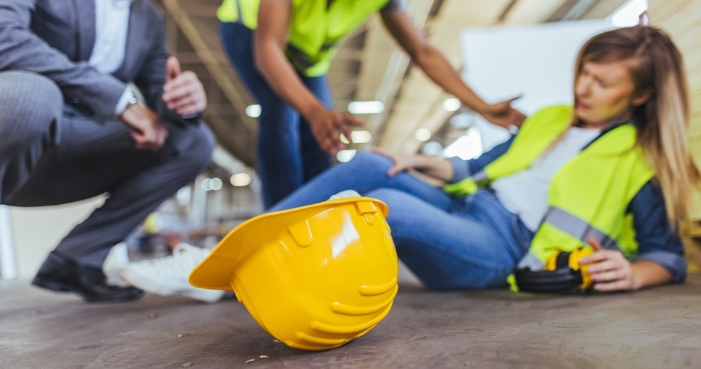 A worker is tended to after an incident in a factory