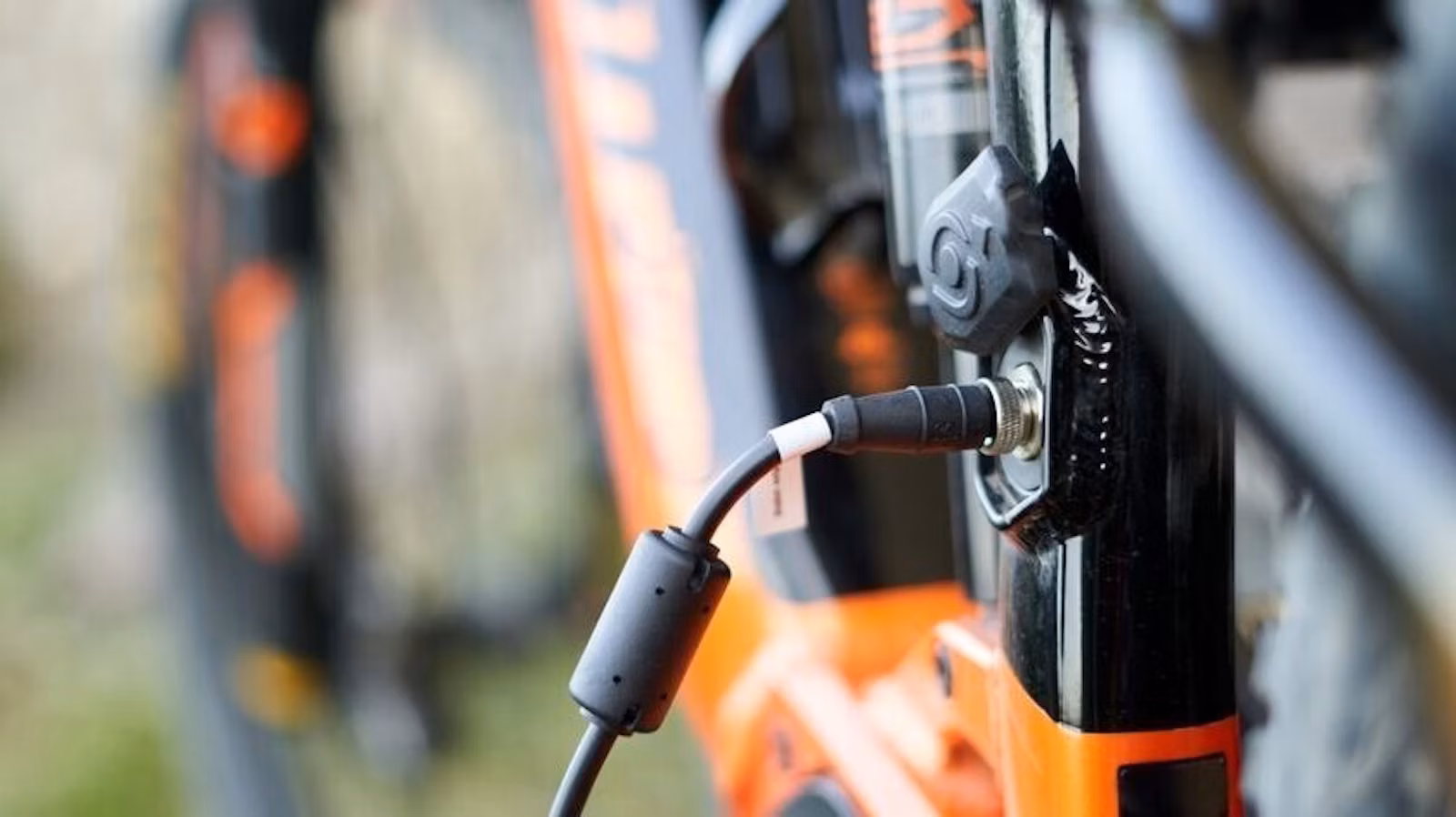 Close up of an e bike plugged in charging blog image