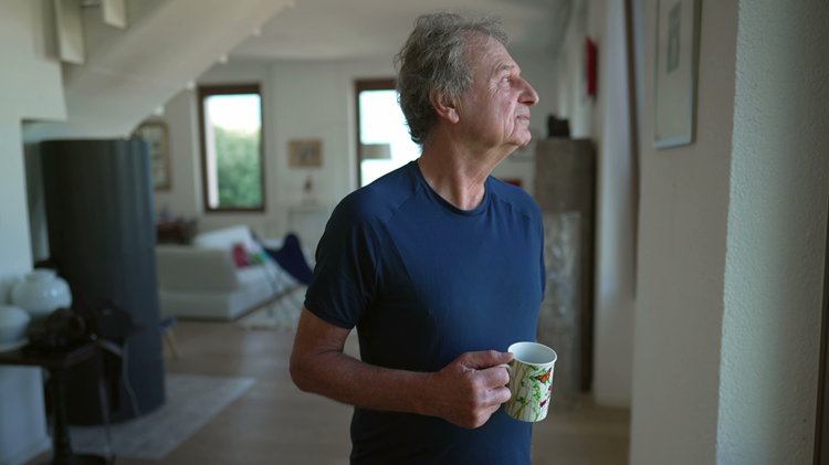 Man staring out of window asbestos