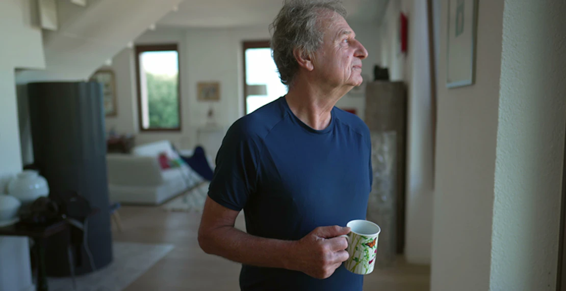 Man staring out of window asbestos