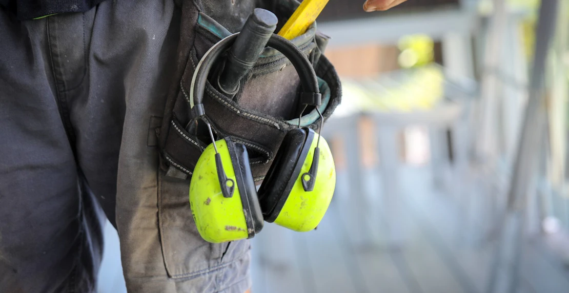 Man with construction belt harness